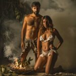 Couple in elegant lingerie beginning initiation ritual at a swinger club.